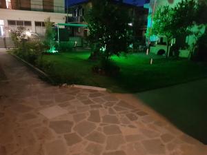 a night view of a lawn with green lights at MAGDALINOS APARTMENTS (3) in Nea Skioni