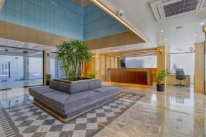 an office lobby with a planter with plants in it at The Vincent inn in Bhopal