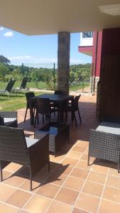 eine Terrasse mit einem Tisch und Stühlen auf einer Terrasse in der Unterkunft Apartamentos La Ardina in Celorio