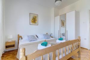 a bedroom with a large bed and a mirror at Miro in Senj