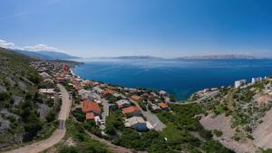 an aerial view of a village on the shore of a lake at Miro in Senj