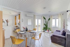 a living room with a table and chairs and a couch at Miro in Senj