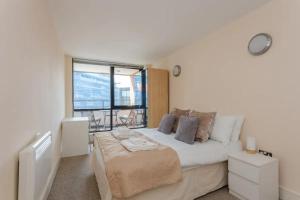 a bedroom with a bed and a large window at Vivid Apartment in Central London in London
