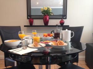 a breakfast table with breakfast foods and orange juice at ** SPECIAL OFFER ** Half price - Book your Double room with us now in Willand