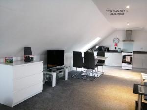 a living room with a table and chairs and a kitchen at Boleyn house in Bodmin