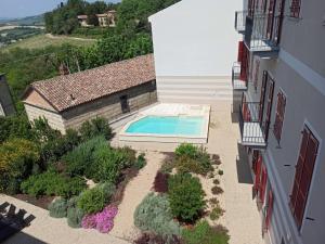 an external view of a house with a swimming pool at OLIVOLA APARTMENTS in Frassinello