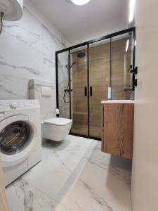 a bathroom with a washing machine and a toilet at Apartments Santos in Vrsar +65 photos