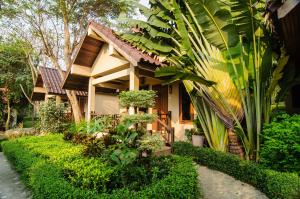 a house with a garden in front of it at Ao Cho Grandview Hideaway Resort in Ko Samed