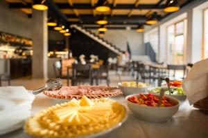 a table topped with plates of food on a table at Penzion Panský dvůr Telč in Telč