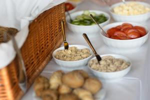 a table topped with bowls of food with vegetables at Penzion Panský dvůr Telč in Telč