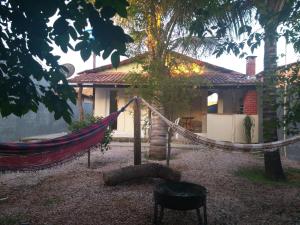 a hammock in front of a house at Casa Estrela de Jorge in Sao Jorge
