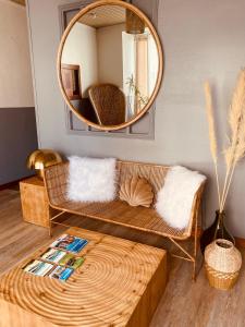 a living room with a couch and a mirror at Hôtel de l'Europe-Gare centre in Saint Malo