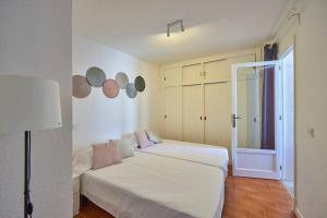 a bedroom with two beds and a window at Nura Houses Apatment Magaluf 4 in Magaluf
