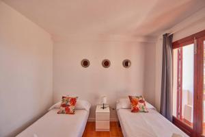 a room with two beds and a window at Nura Houses Duplex Magaluf 1 in Magaluf