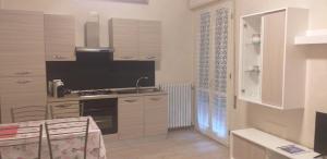 a kitchen with white cabinets and a sink in it at Appartamento Fiore in Bagnolo Mella