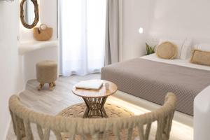 a bedroom with a bed and a table with a book on it at Majestique of Naxos boutique hotel in Naxos Chora