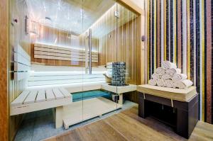 a bathroom with a sauna with a glass wall at Prestige Hotel Budapest in Budapest