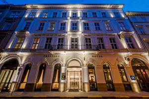 a large building in a city at night at Prestige Hotel Budapest in Budapest
