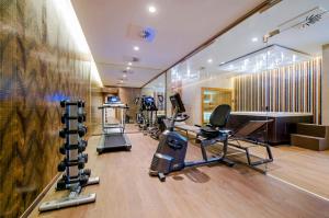 a gym with treadmills and exercise equipment in a room at Prestige Hotel Budapest in Budapest