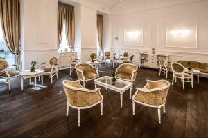 a large room with chairs and tables and a room withermottermottermott at Prestige Hotel Budapest in Budapest