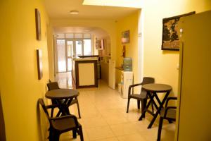 a room with two tables and chairs and a kitchen at Hotel Casa Alejandria in Quimbaya