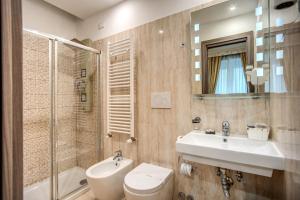 a bathroom with a toilet, sink, and shower at Hotel Centro Cavour Roma in Rome