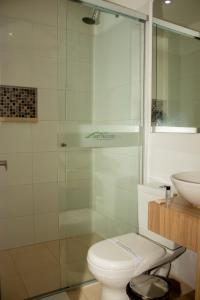 a bathroom with a shower and a toilet and a sink at Hotel Valle de San Nicolas in Rionegro