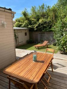 a wooden picnic table on a deck with two benches at Niarnia in Abbeville