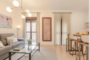 a living room with a couch and a table at Green-Apartments Pleno Centro in Seville