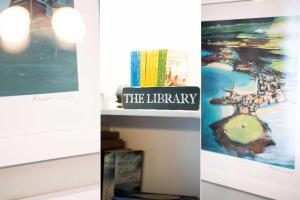 three pictures of the library and a shelf with books at Picture House in St Ives