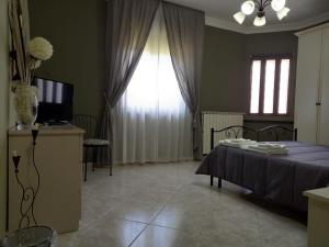 a bedroom with a blue bed and a window at B&B TENUTA BIANCA in Oliveto Citra