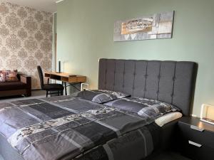 a bedroom with a large bed and a desk at HoteLPension am Thermalbad in Bad Nenndorf