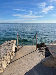a stairway leading to a large body of water at Casa David in Piran