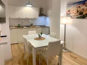 a kitchen with a white table and white chairs at Residence D'azeglio in Palermo