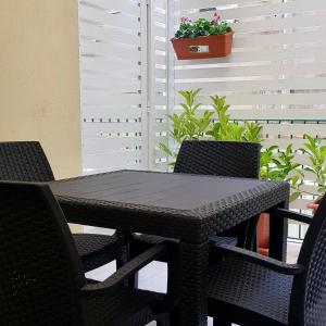 a black table and chairs on a patio at Residence D'azeglio in Palermo +43 photos