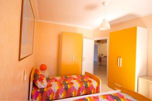a bedroom with a bed and yellow cabinets at Sophie's Choice 2 in Rome