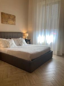 a bedroom with a bed and a window with white curtains at B&B Oriental Palace in Catania