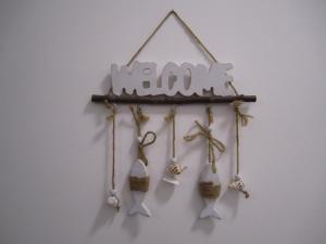 a group of bells hanging on a wall at Casa Casella, delizioso bilocale a due passi dal mare in Lido di Ostia +31 photos