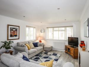 a living room with a couch and a tv at Glantraeth in Holyhead