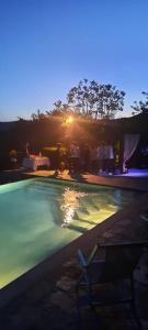 a swimming pool with the sunset in the background at Casolare il Moro in Monte San Savino