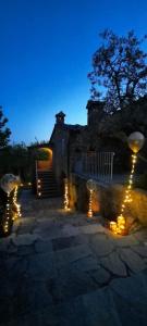 a house with lights in front of it at night at Casolare il Moro in Monte San Savino