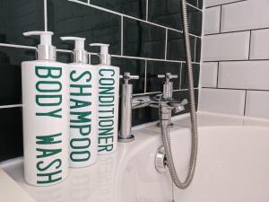 a sink with two toothbrushes on top of it at Stylish penthouse apartment in Ramsgate