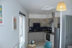 a kitchen with a glass table in a room at Stylish penthouse apartment in Ramsgate