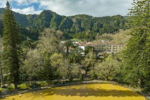 an aerial view of a park with a large yellow pond at Terra Nostra Garden Hotel in Furnas