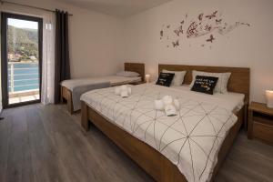 a bedroom with two beds and a window at Apartments Suzy in Šibenik