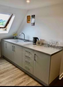 a kitchen with a sink and a counter with wine glasses at Rother - Studio in Rye - LOCATION,LOCATION,LOCATION !!! in Rye