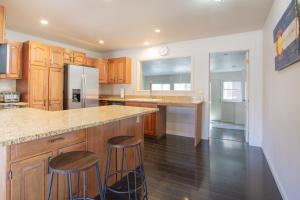 a kitchen with wooden cabinets and a counter with stools at Spacious 4 bedroom house close to everything! in Salida