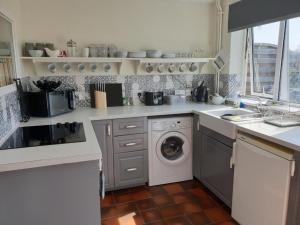 uma cozinha com uma máquina de lavar roupa e uma máquina de lavar louça em Yew Tree Bungalow, Onneley, Cheshire em Crewe