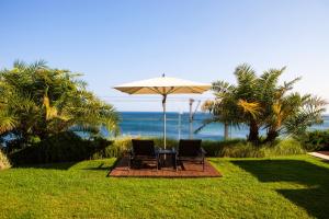 a table and two chairs under an umbrella at InterContinental Cascais-Estoril by IHG in Estoril
