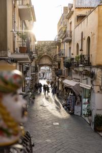 people walking down a street in a city at Taodomus Small Boutique Hotel in Taormina